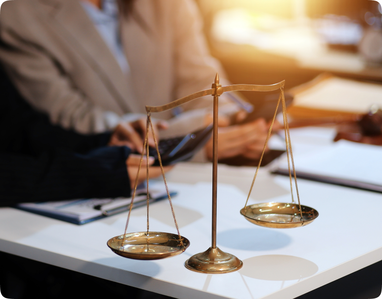 Scales of justice on a desk in soft light